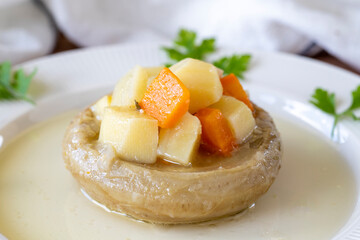 Artichokes with olive oil on wood background. Traditional Mediterranean cuisine delicacies. local name zeytinyagli enginar. Close up