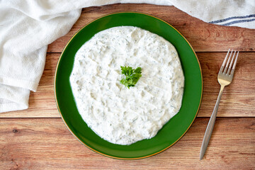 Dry tzatziki on wood floor. Snack prepared with yogurt and mint. Traditional Mediterranean cuisine delicacies. Local name kuru cacik or tzatziki. Top view
