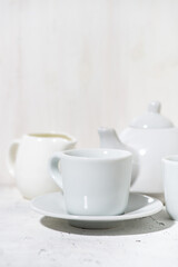 Obraz na płótnie Canvas white utensils for tea drinking closeup, vertical