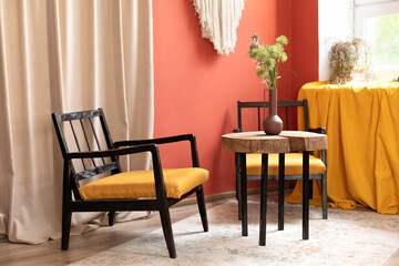 Table with saw cut wooden. retro wooden chair at home. Modern retro composition of living room interior with design stylish armchair and wooden coffee table. Elegant interior of room with home decor.	