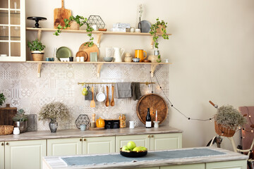 Stylish scandi cuisine interior decor. Ceramic plates, dishes, utensils and cozy decor on wooden shelfs. Kitchen wooden shelves with various ceramic jars and cookware. Open shelves in the kitchen.	