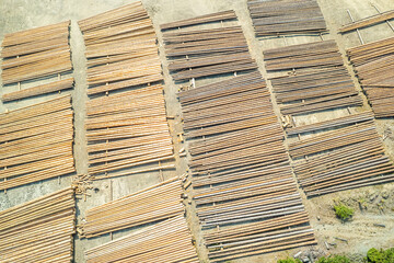 Aerial view of sawmill with timber, chopped  a lot of pine tree wood logs. Top, drone view