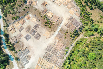 Aerial view of sawmill with timber, chopped  a lot of pine tree wood logs. Top, drone view
