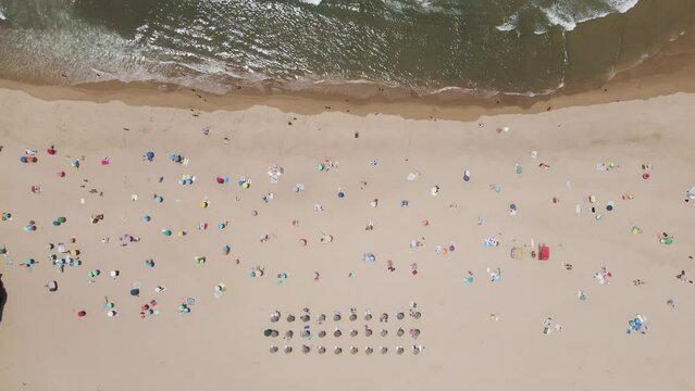 Aerial view of Praia de Odeceixe with people on the beach, Odeceixe, Faro, Portugal.