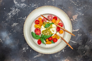 burrata cheese,. fresh vegetables salad on a dark background. Healthy eating concept. Restaurant menu, dieting, cookbook recipe top view