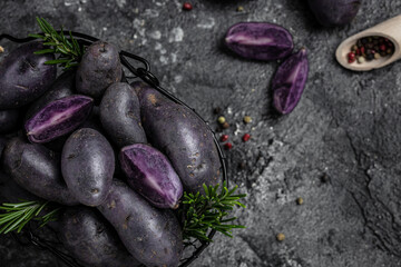 Raw purple sweet potato food on a dark background. banner, menu, recipe place for text, top view