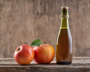 Apple vinegar with apple fruit on old wooden background