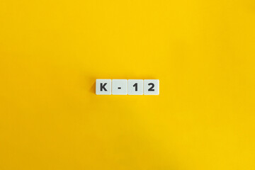 K-12 (Kindergarten to Twelfth Grade) Education Program.
Letter Tiles on Yellow Background. Minimal Aesthetics.