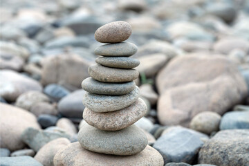Fototapeta na wymiar Pyramid of stones on the beach. Balanced stones. Pile of stones. Pyramid of sea pebbles. Life balance, harmony concept