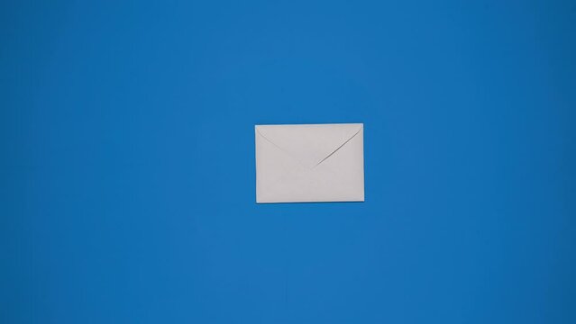 Sending letter. Stop motion animation with paper envelope on blue background. Sending Files by mail or email. The document form and envelope
