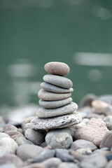 Balanced pebble pyramid on the beach with Sea on the background. Rest, seaside vacation concept.