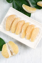 Fresh pomelo fruit on white table background.
