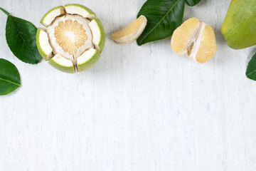 Fototapeta na wymiar Fresh pomelo fruit on white table background.