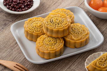Delicious Cantonese moon cake for Mid-Autumn Festival food mooncake on wooden table background.