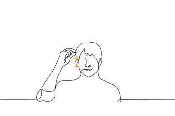 smiling man shows a key on a chain - one line drawing vector. concept buying a home, moving to a new house, realtor