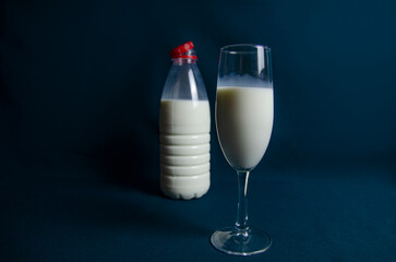 milk in a glass on a dark background