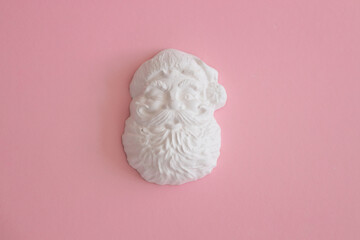 Plaster figure of Santa Claus on a colored background