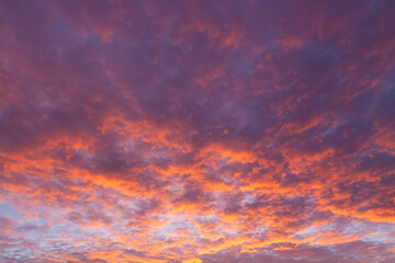 Naklejka na ściany i meble Beautiful pink sunset cloudy skies at dusk