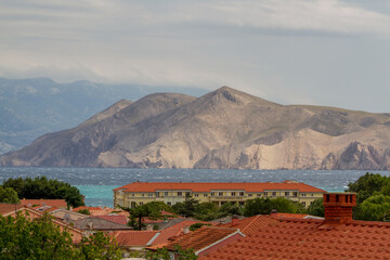View over the roofs of Baska, island of Krk, Croatia with Mediterranean Sea and mountains