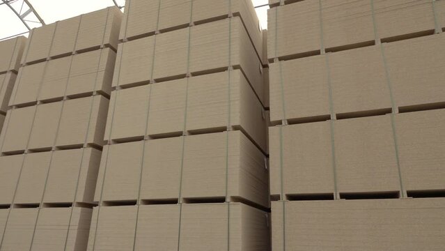 mdf boards and chipboards storing at factory, production, manufacture and woodworking industry concept - chipboards processing.