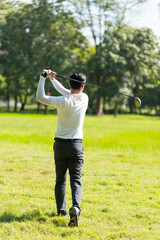 Close up professional  golf player with club on course