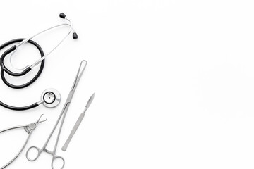 Dental or surgical steel instruments with stethoscope. Healthcare background