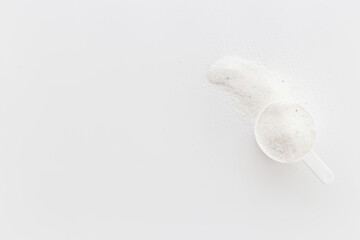 White washing powder with measuring scoop. Laundry day concept