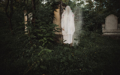 scary ghost in cemetery at night Halloween background