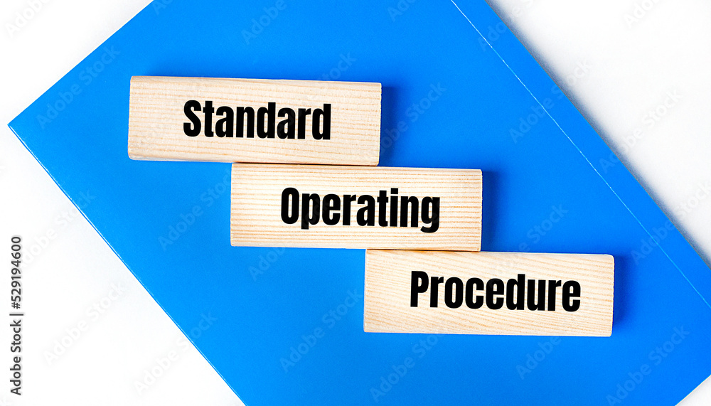 Aufkleber there is a blue notebook on a light gray background. above are three wooden blocks with the words so