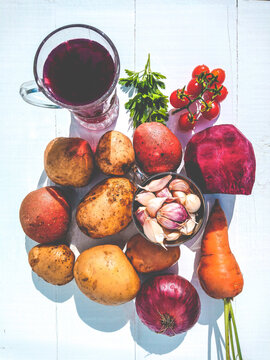 Products for autumn borscht lie on a white background. Preparation of borscht in vertically