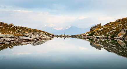 Back view person female stand on edge in nature calm landscape look to sides search purpose in life...