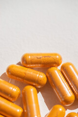 Turmeric plus black pepper extract gelatin capsule close up top view. Herbal supplement organic curcumin. Supports antioxidant health