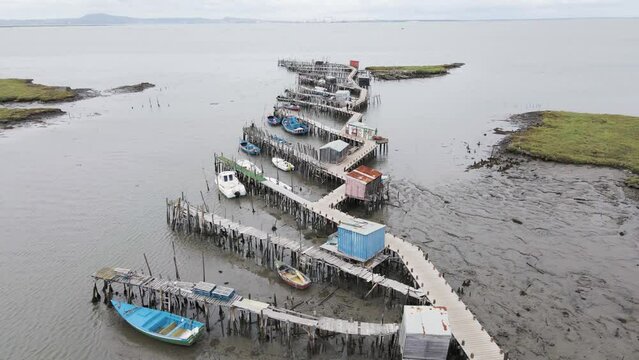 Aerial view of Porto Palafita da Carrasqueira, a beautiful pier made of wood by fishermen renowned for its sunset view, Comporta, Troia Peninsula, Setubal, Portugal.