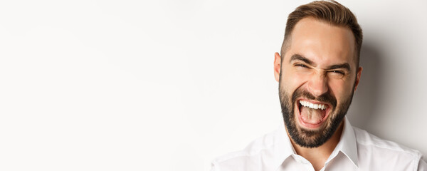 Emotions and people concept. Headshot of happy attractive man laughing and smiling, looking...