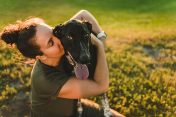 Woman and her friend dog on the Beautiful sunset background