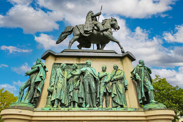Cologne (Heumarkt), Germany - July 9. 2022: Equestrian bronze and stone monument for king William III of prussia, blue summer sky, fluffy clouds