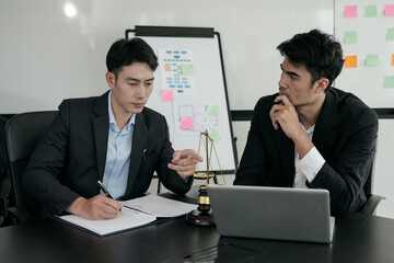 A female lawyer is consulting with a team in the office to resolve the issue Lawyer Fight for Freedom of Her Client with Supporting Evidence