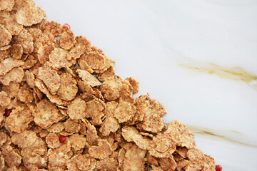 sweet dry diet wheat muesli on a gray marble background, texture close-up