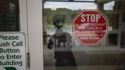 Sign posted at entrance to for their security and safety at school saying that all visitors must report to the office and push button for entrance.