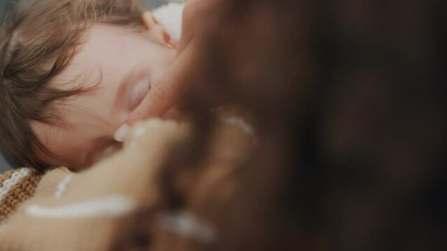 Breastfeeding, baby and mother feeding her tired, sleepy and healthy infant child. Love, care and nurture with parent giving sucking kid breast milk for health, nutritient and growth at home