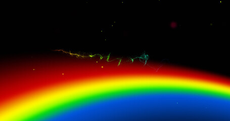Fototapeta na wymiar Image of rainbow and colourful light trail moving on black background