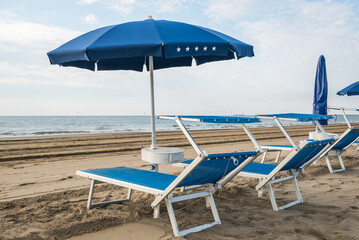 Seashore landscape. Summer holiday destination in Italy. Sandy beach in sunlight.