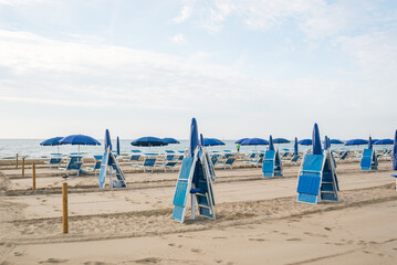 Seashore landscape. Summer holiday destination in Italy. Sandy beach in sunlight.