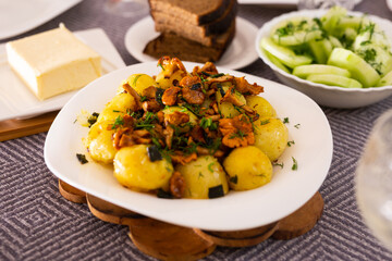 rustic dish. fried potatoes with chanterelle mushrooms with herbs