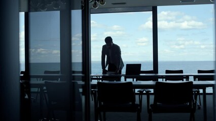 Silhouette business people using tablet in marine view office. Partners talking - Powered by Adobe