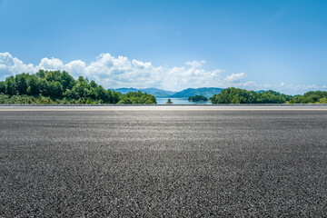 Empty asphalt road and mountain nature scenery under blue sky. Road and mountain background.