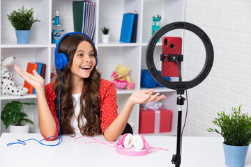 Young blogger girl recording video for blog. Teen girl speaking in front of camera for vlog....