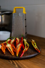 cut pods of red hot pepper on a wooden board