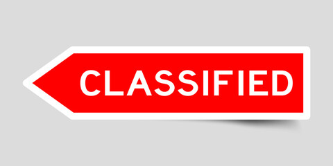 Red color arrow shape sticker label with word classified on gray background