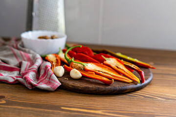 cut pods of red hot pepper on a wooden board